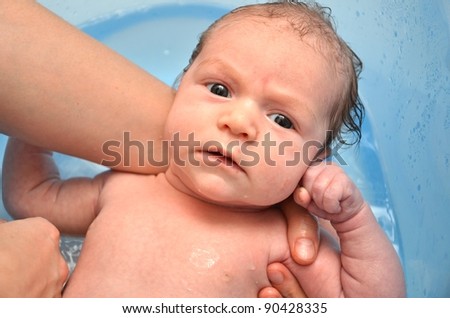 Similar – Image, Stock Photo Newborn in the bathtub held by her mother