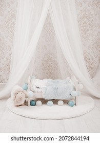 Newborn Baby Bed With A Little Sheep In A Photo Studio