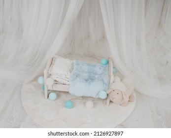 Newborn Baby Bed With A Little Sheep In A Photo Studio