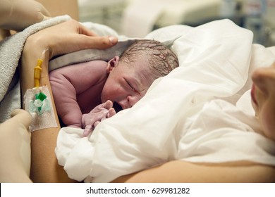 Newborn Baby Boy After Birth Is On Her Mother's Arms