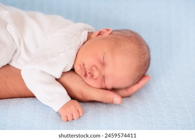 Newborn baby boy in bed. New born child sleeping under a blue knitted blanket. Children sleep. Bedding for kids. Infant napping in bed. Healthy little kid shortly after birth. Cable knit textile. - Powered by Shutterstock