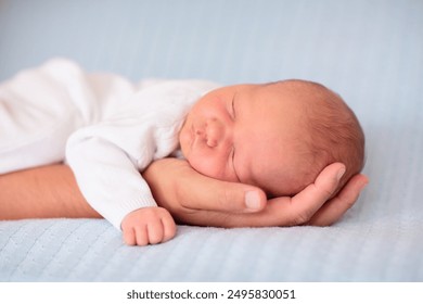 Newborn baby boy in bed. New born child sleeping under a blue knitted blanket. Children sleep. Bedding for kids. Infant napping in bed. Healthy little kid shortly after birth. Cable knit textile. - Powered by Shutterstock