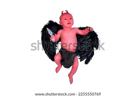 A newborn baby boy with black demon wings, isolated on a white background. An infant caucasian child in a diaper aged one month