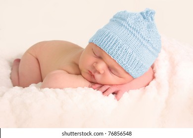 Newborn Baby Boy In A Blue Knitted Hat.