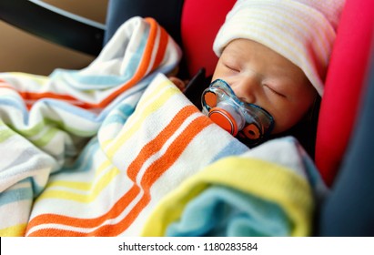 Newborn Baby Boy In A Car Seat With A Blanket