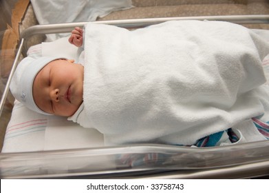 Newborn Baby Boy In Hospital Bassinet