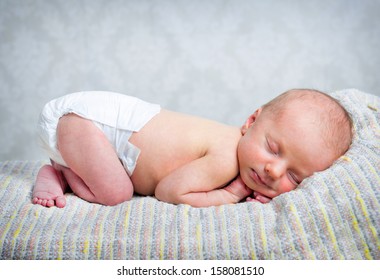 Newborn Baby Boy Sleeping In A Diaper