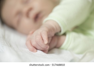 Newborn Baby Boy Sleeping On White Blanket