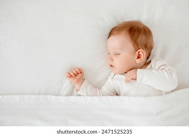 Newborn baby boy sleeping under a blanket in a white bodysuit on the bed with his hand folded under his cheek, sweet healthy baby sleep at home - Powered by Shutterstock