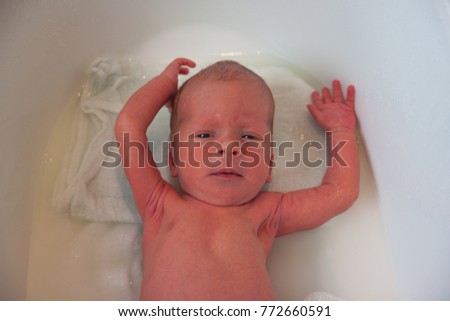 Similar – Newborn in the bathtub with her mother washing her hair