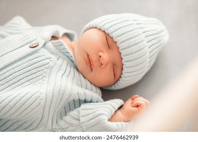 Newborn baby boy wearing knitted hat and sweater in crib at home close up. Childhood.  - Powered by Shutterstock