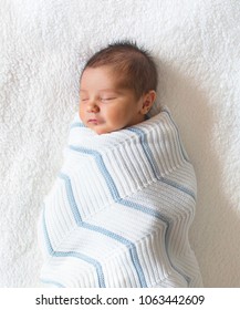 Newborn Baby Boy Wrapped In Blanket