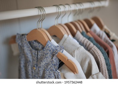 Newborn Baby Clothing On Hangers In Closet In Cute Childs Room Interior