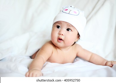 Newborn Baby With Cow Hat Lying Down On A Blanket