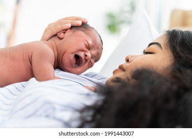 Newborn Baby Crying On Mother's. Mother Take Care Her African American Infant On Hands With Kindness. Family, Love, Happy And New Life Concept