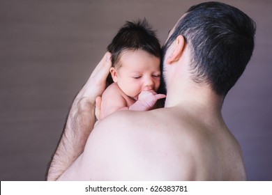 Newborn Baby And Dad. Baby Boy Crying On His Father Shoulder.