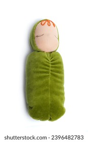 Newborn baby doll. Soft handmade toy on white background. Green color natural cotton linen material doll