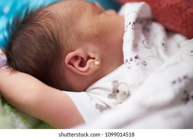 Newborn Baby With Earring Close Up View Sleeping