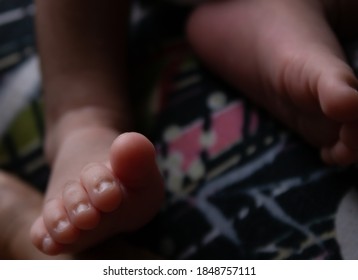 Newborn Baby Feet In Bed Focused In Finger Nails Of A Indian New Born Baby