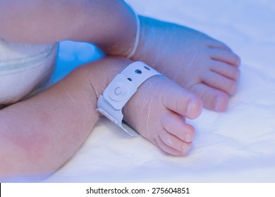 Newborn Baby Foot With Identification Hospital Tag Name Under Uv 