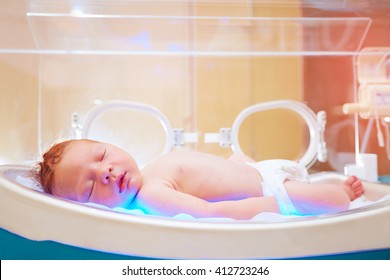 newborn baby get the light therapy in infant incubator