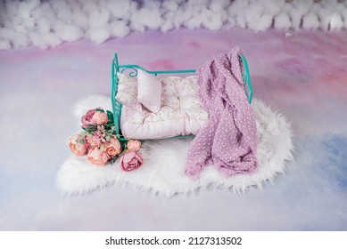 Newborn Baby Girl Bed With Pink Flowers In A Photo Studio