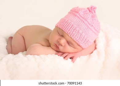 Newborn Baby Girl In A Knitted Hat.