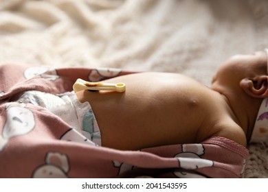 Newborn Baby Girl Laying Down With Umbilical Cord Still Attached - Side View