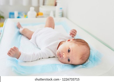 Newborn Baby Girl Lying On Changing Table