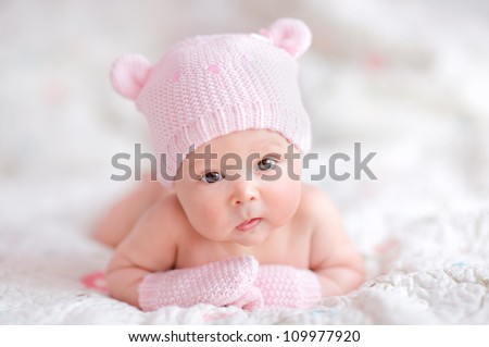 newborn baby girl in pink knitted bear hat