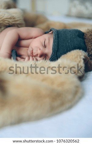 Similar – Newborn baby with pompom hat sleeping on blanket