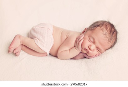 Newborn baby girl posing on white background