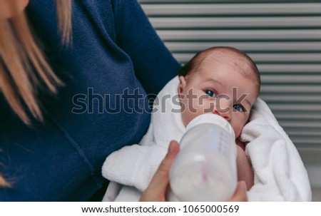 Baby taking feeding bottle