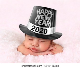 Newborn Baby Girl Wearing A Happy New Year 2020 Hat. 