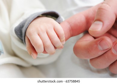 Newborn Baby Holding Father's Finger