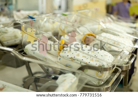 Newborn baby in hospital in bassinet blur background