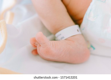 Newborn Baby In Hospital With Identification Bracelet Tag Name