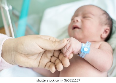 Newborn Baby In Hospital With Identification Bracelet Tag Name