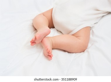 Newborn Baby Legs On The Bed