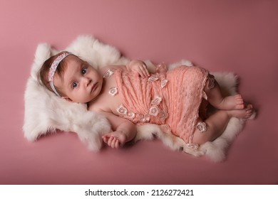 Newborn Baby Lies And Sleeps On A White Fur Blanket . Love