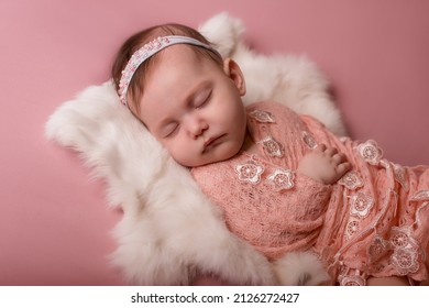 Newborn Baby Lies And Sleeps On A White Fur Blanket . Love