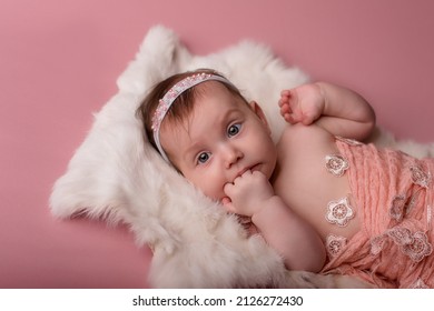 Newborn Baby Lies And Sleeps On A White Fur Blanket . Love