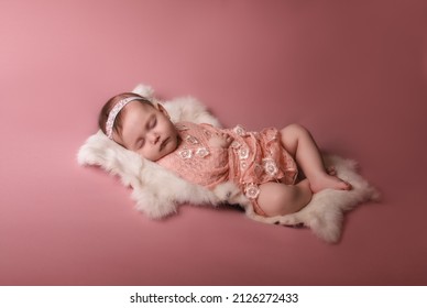 Newborn Baby Lies And Sleeps On A White Fur Blanket . Love