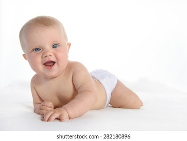 Newborn Baby Lying Down On White Blanket Looking At Camera Smilng Happy Studio Shot