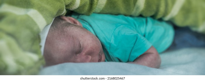 Newborn Baby Lying Down Sleeping Outdoor In The City Park At Sunset