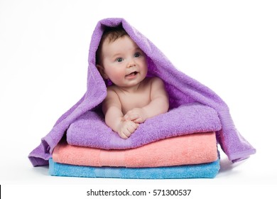 Newborn Baby Lying On A Stack Of Towels