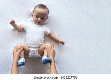 Newborn Baby Massage. Mom Doing Gymnastics With Kid. Mommy Massaging Her Cute Baby Boy. Moving A Baby's Legs, Relieve Constipation. Mother Doing Exercises And Movements To Stimulate A Baby's Bowels.