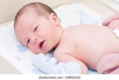 Newborn Baby In Maternity Hospital Looking At The Camera