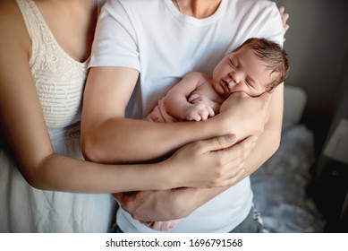 Newborn Baby With Mom And Dad At Home
