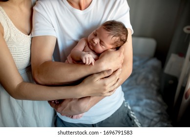 Newborn Baby With Mom And Dad At Home
